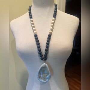 Handmade wooden, oyster shell, and resin necklace. Navy blue and off white beads
